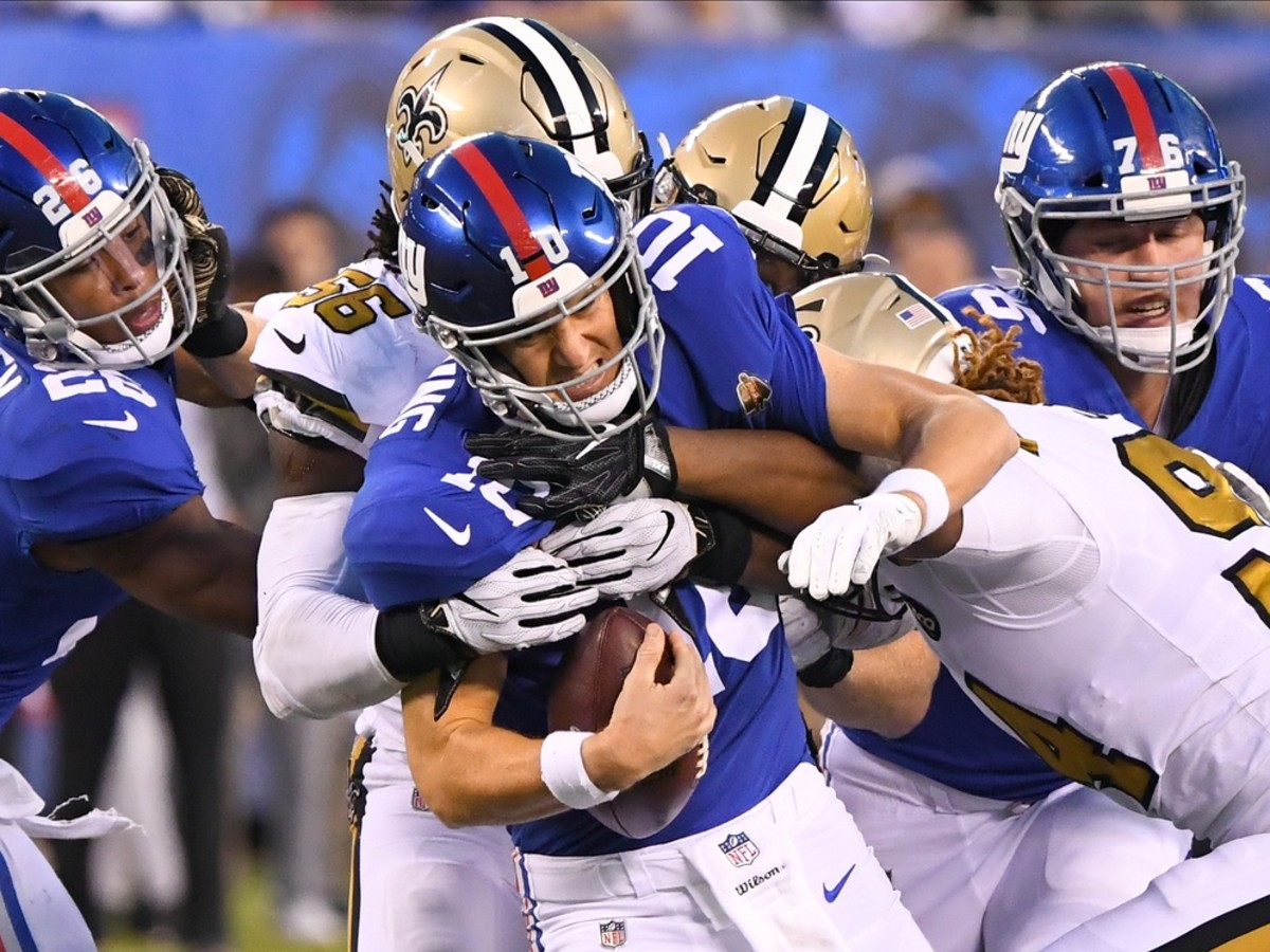 New York Giants quarterback Eli Manning (10) gets sacked by New Orleans Saints linebacker Demario Davis (56) and defensive end Cameron Jordan (94). Mandatory Credit: Robert Deutsch-USA TODAY 